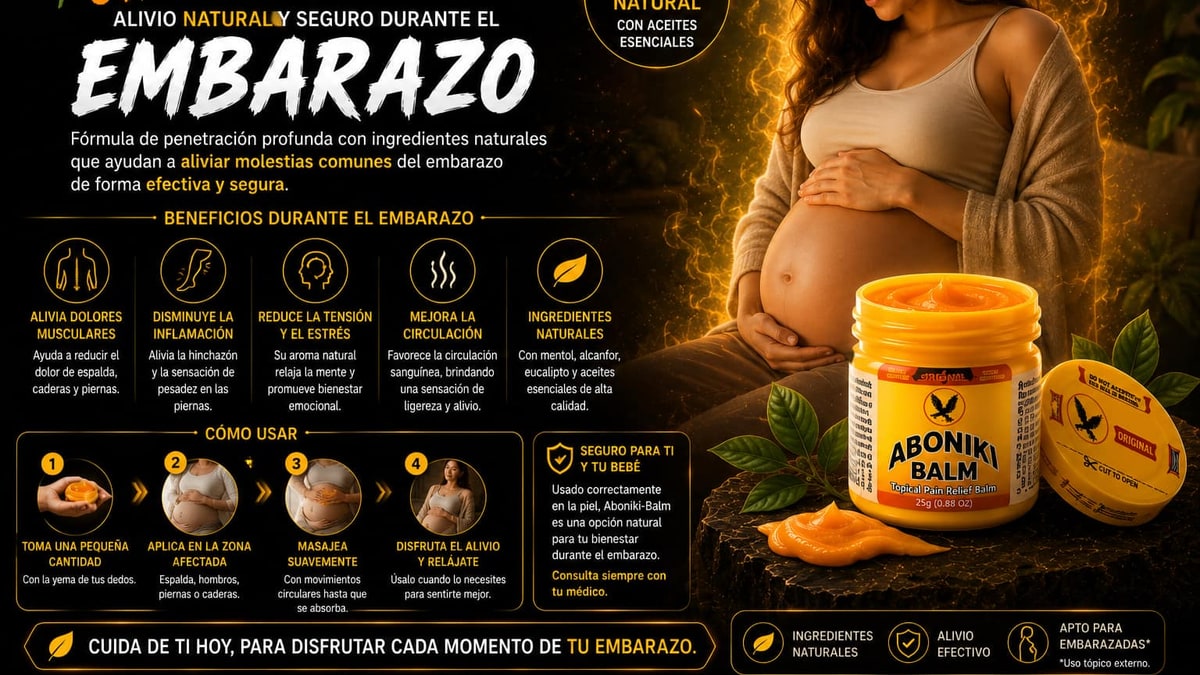 Mano de mujer embarazada sobre vientre con luz dorada cálida sobre fondo oscuro